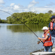 Son and father fishing in a boat on the Caboolture River