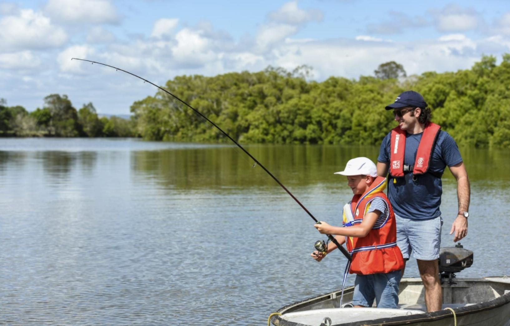 Son and father fishing in a boat on the Caboolture River